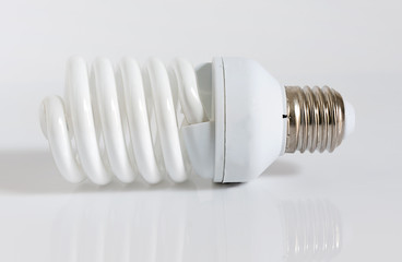 Close up of a energy saving fluorescent light bulb on a white bakground