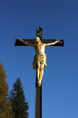 Cross in countryside with blue sky