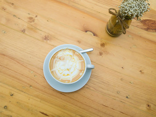 Close up cup of Coffee, latte on the wooden table