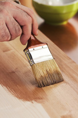 Man painting some wooden boards