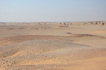 Fototapeta na wymiar Stones and sand dunes in Oman