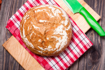 bread floured and knife placed on a wooden background