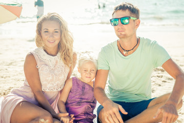 Fototapeta na wymiar Happy family enjoying time on the beach