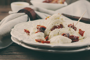 Traditional italian antipasto with burrata and dry tomato