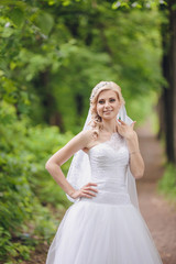 Fototapeta na wymiar Beautiful bride outdoors in a forest park