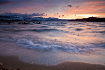 waves roll in to shore of a mountain lake