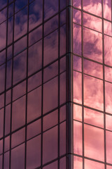 Sky and clouds reflected in windows of office building