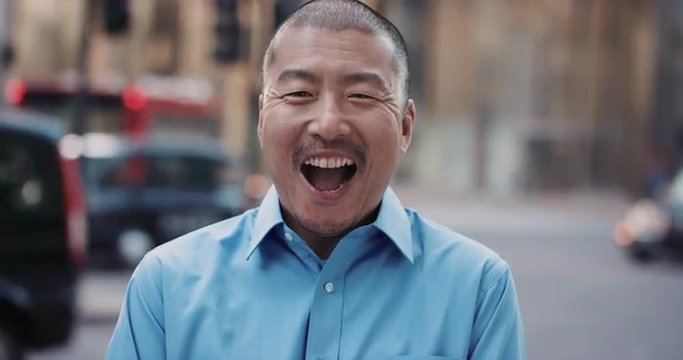 Slow Motion Portrait of Japanese businessman laughing