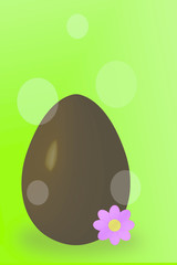 Chocolate egg with flower on the green background and light effects.