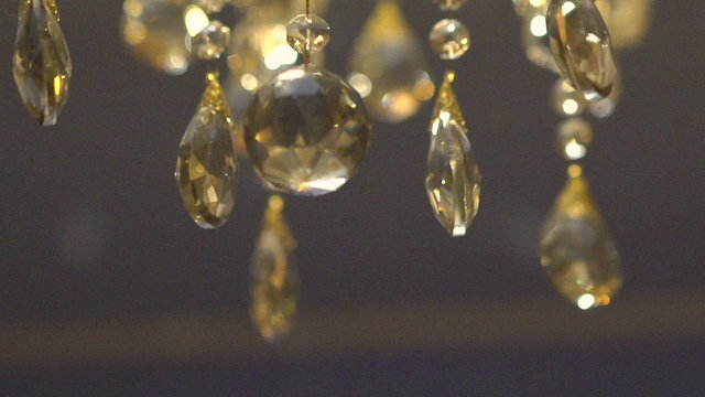Moving of a luxury crystal gold chandelier. Beautyful background. Slowly