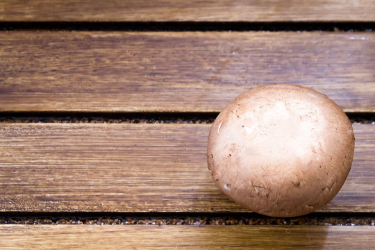 Brown champignon on wooden background 