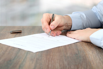 Businessman is signing a contract, business contract details
