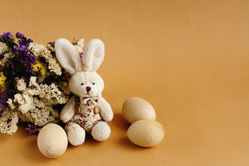 willow buds flowers and wooden eggs and bunny on craft backgroun