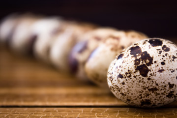 Quail eggs on wooden background 