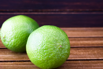 Limes on wooden background 