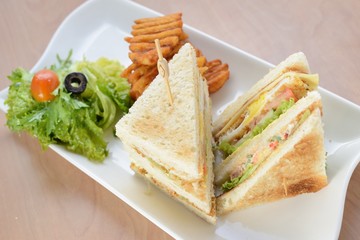 Freshly made club sandwiches served with potato chips