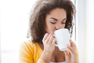 Pleasant woman drinking tea