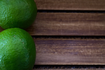 Limes on wooden background 