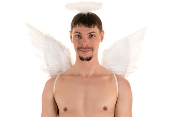 topless young man with white angel wings on back and halo over his head looking at the camera and...