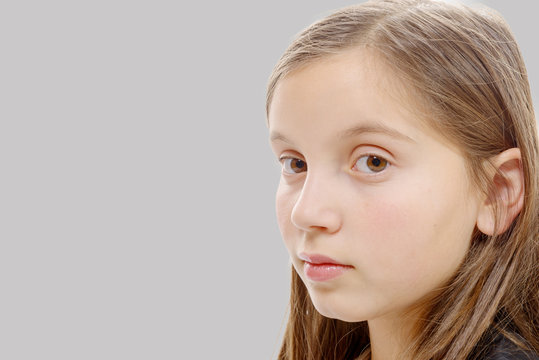 portrait of pre teenage girl isolated on  grey background