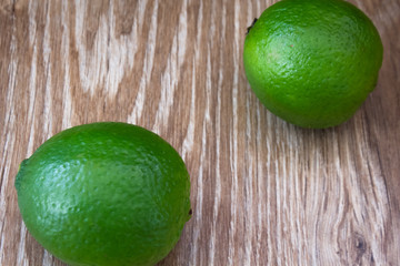 Limes on wooden background 