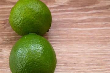 Limes on wooden background 