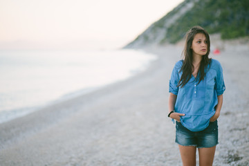 Portrait of young woman standing at the beach