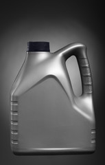 canister with engine oil isolated on black and white gradient ba