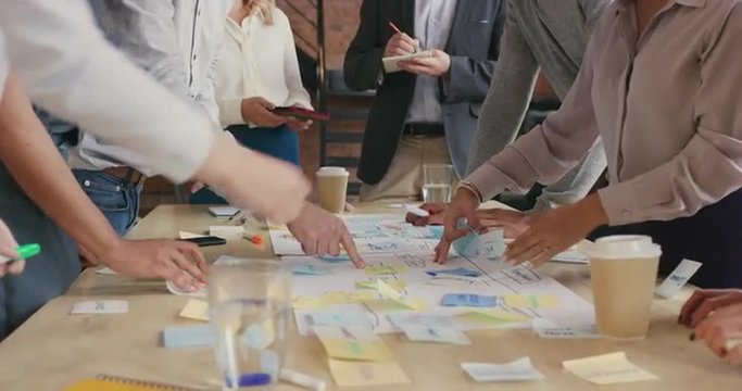 Steadicam shot in of creative diverse business team meeting 