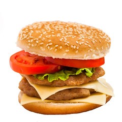 big hamburger with sesame seeds, fresh vegetables and juicy meat