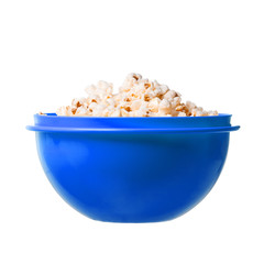 Salted popcorn grains in blue dish on white background