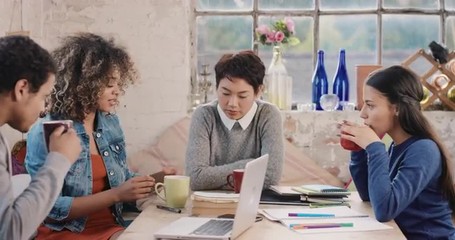 Diverse group of students studying at home using books and laptop technology - Powered by Adobe