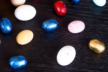 Ovetti pasquali di cioccolato e zucchero su sfondo nero 