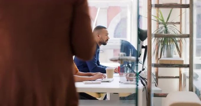 Mixed race team of young business people working in open plan office with diverse group of people showing equality concept