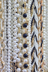 collection of pearl necklaces and gold chains