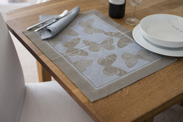 Placemat with Butterfly Design on Table with Bowl and Utensils - Powered by Adobe