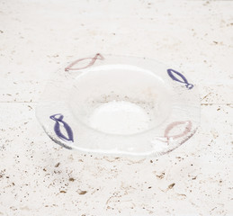 A Crystal Ashtray with Blue and Gray Fish Design