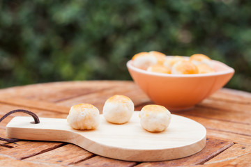 Mini Chinese cakes on wooden plate