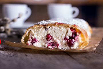 Strudel or pie with cranberries and cheese and two cups of coffee