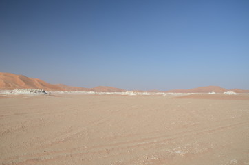 Fototapeta na wymiar White rocks and sand dunes sahara desert