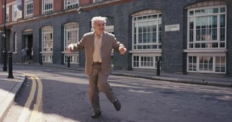 Contemporary funky elderly man street dancer dancing freestyle in the city