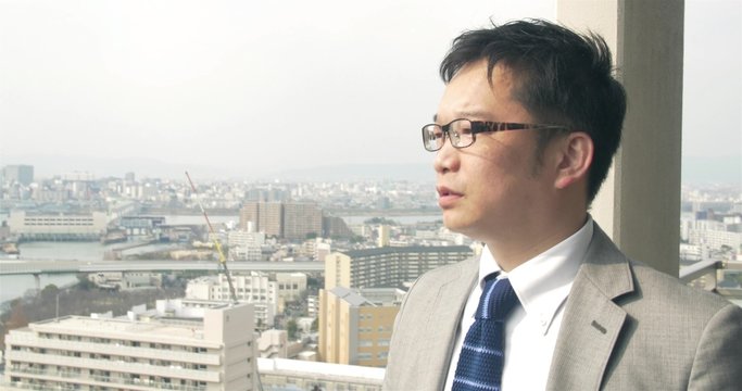 Japanese businessman looks over the city