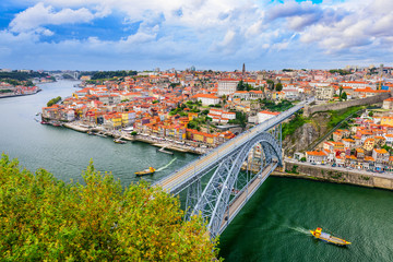 Fototapeta na wymiar Porto, Portugal cityscape on the Douro River and Dom Luis I Bridge.