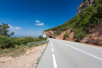 Rural road among rocks at summer