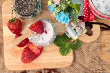 Chia seeds with milk and fresh strawberries.