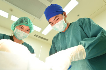 two veterinarian surgeons in operating room