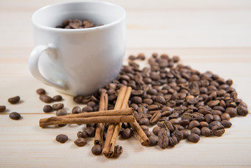 coffee beans in cup. Coffee cup and coffee beans on wooden background. coffee with cinnamon, coffee with additives
