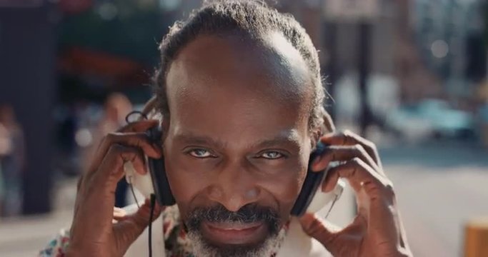 Slow Motion Portrait of happy mature african american man listening to music