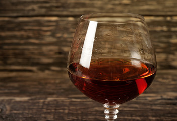 Closeup cognac, brandy or whiskey in large round glass