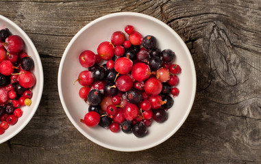 Summer berries and ice in white bowl
